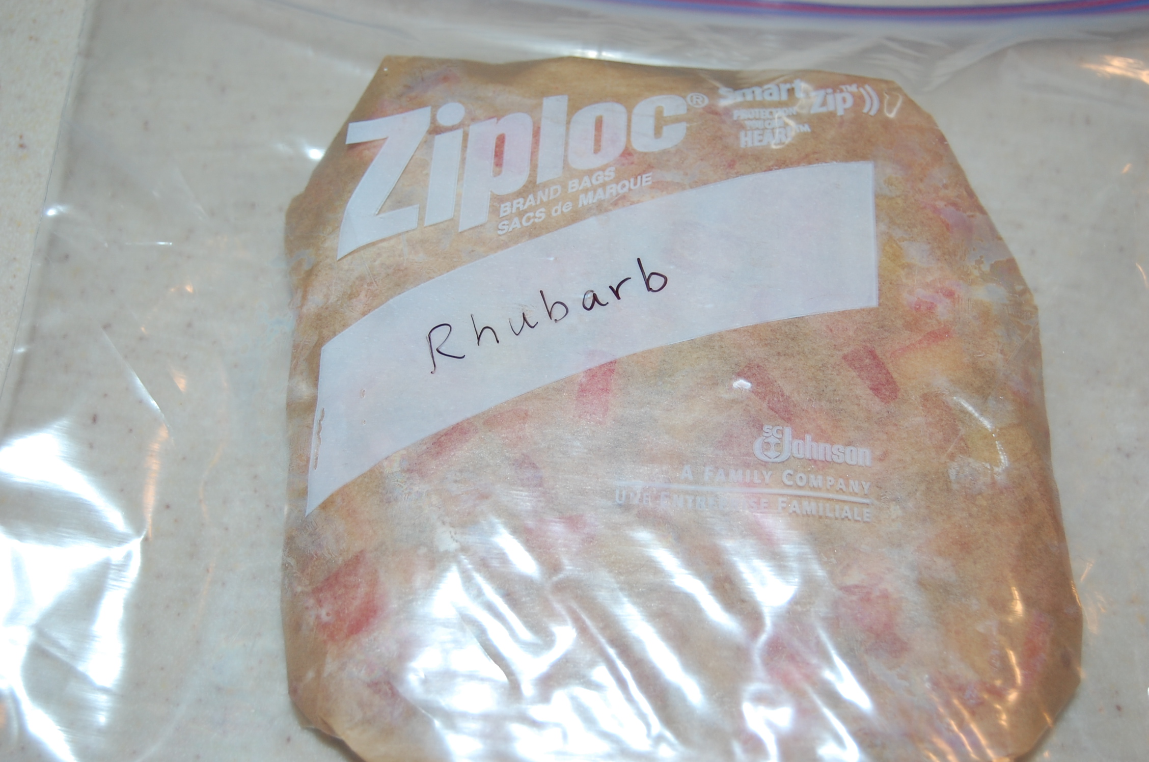 DSC_0013 The parchment paper-wrapped rhubarb inside a labeled freezer bag.