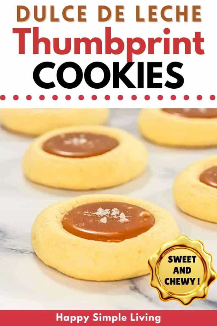 Close up of five dulce de leche thumbprint cookies filled with caramel and topped with sea salt flakes.