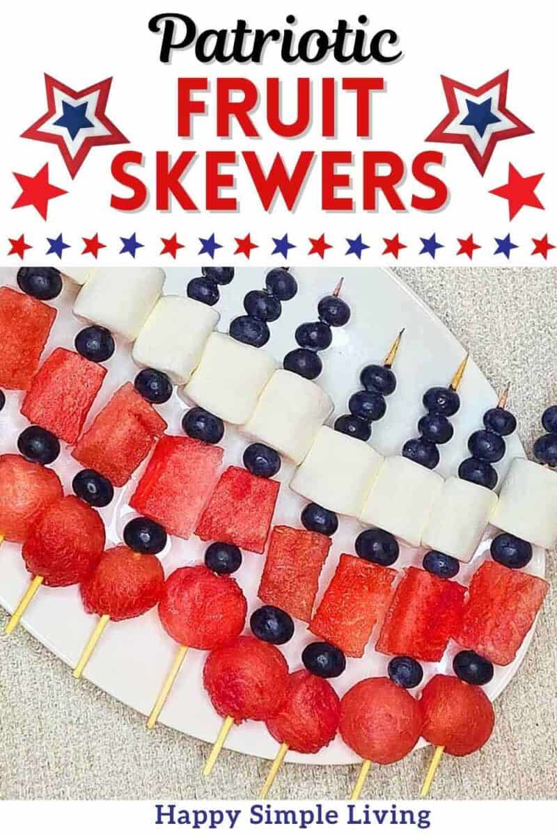 Patriotic fruit skewers arranged on a white dish.